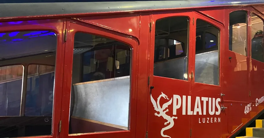 Close-up of a red cog railway car at the station