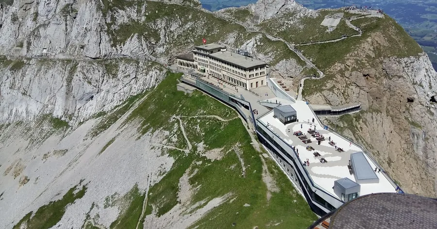 The summit buildings of Pilatus Kulm on the rocky ridge, seen from the air