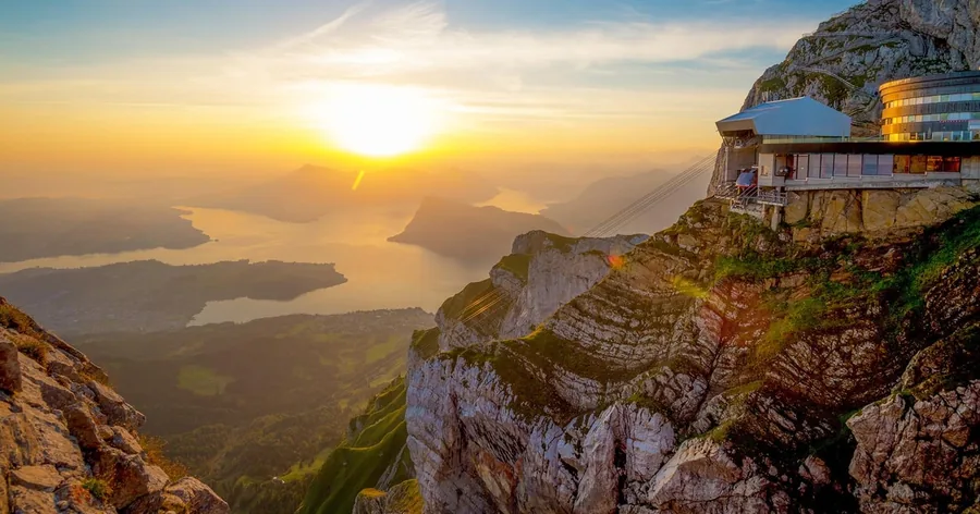 Sunset over Lake Lucerne seen from the summit, with the hotel on the cliff edge